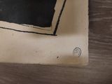 a black and white picture of a clock on a table