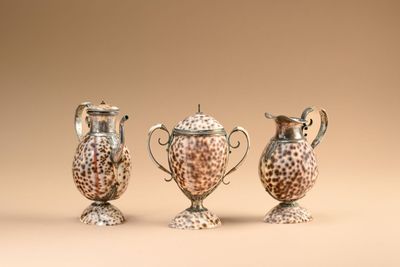 three different sized vases sitting on top of a table next to each other