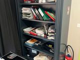 a book shelf with many books on it in a room