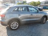 a silver car that is parked in a parking lot