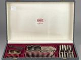 silverware in a case with a red lining on a gray surface