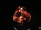 an orange diamond is shown on a black surface