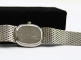 an image of a silver wrist watch with a black box in the background
