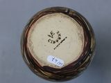 a close up of a vase with a tag on it