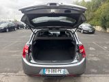 cars are parked in a parking lot with the trunk open