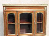 a wooden display cabinet with glass doors on it