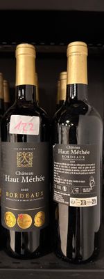 several bottles of wine sit on a shelf in a wine cooler