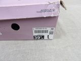 a pink box with a black cat inside of it