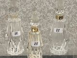 three glass bottles with numbers on them on a table