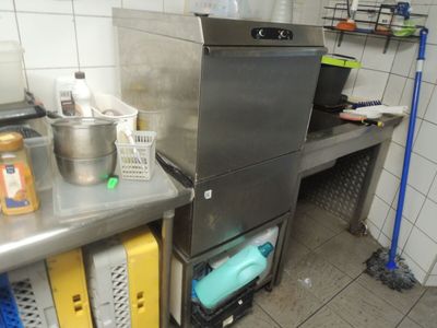 a kitchen with a stove, sink, and other items on the counter