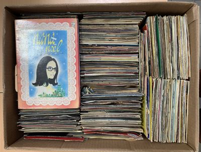 une boîte en carton remplie de livres et la photo d'une femme à lunettes