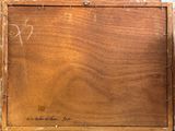 an old wooden box with writing on it sitting on a table