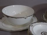 a lot of plates and bowls sitting on a table