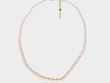 a white pearl necklace with a gold clasp on a white background
