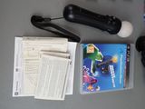 a video game controller, a book, and a game controller on a table
