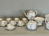 many different types of teapots and cups on the table