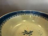 a blue and white bowl with a dragon on it