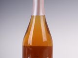 bottles of wine are sitting on a white surface with a gray background