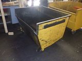 two yellow and black bins sitting next to each other in a room