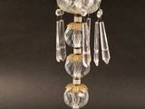une lampe de table en verre avec un pied doré et un abat-jour en verre transparent