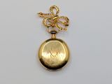 a close up of a gold locke with a bow on it