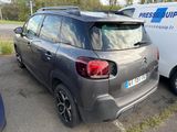 the back of a grey citrole parked in a parking lot