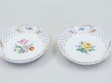 a pair of porcelain dishes with floral designs on them