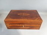 an old wooden box with a decorative design on it