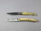 two knives that are sitting next to each other on a table