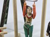 toy figurines of people and a dog on a swing set