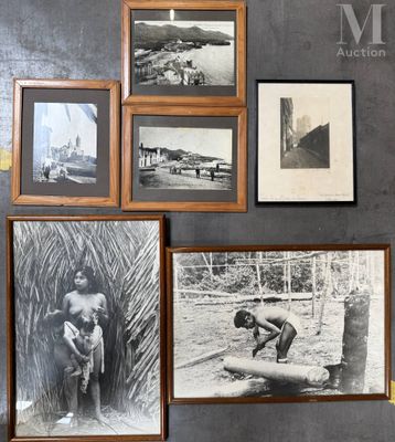 many pictures hanging on the wall of this room