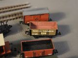 many toy trains that are sitting on a table