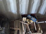 a box of tools sitting on the floor next to a suitcase