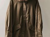 an image of a coat with a fur collar hanging on a hanger