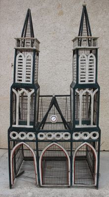 une petite cage à oiseaux surmontée d'une horloge