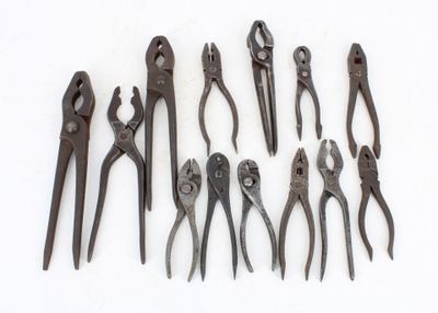several different types of pliers are lined up on a white surface