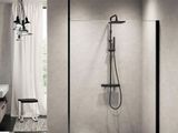 a bathroom with a walk in shower next to a sink and a mirror