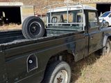 a black truck that is parked in the grass