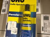 un tube de colle posé sur une boîte en carton