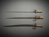 three different types of swords are displayed on a gray surface