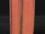 a close up of a book on a table with a black background
