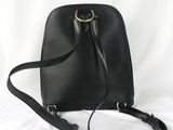 the small black bag is sitting on a white surface