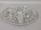 a clear glass plate with a glass candle holder on it
