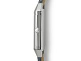 the back of a watch on a white surface with a black strap