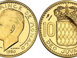 a close up of a gold coin with a crown on it