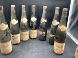 several bottles of wine are lined up in a row on a table