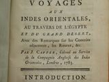 an old book that is open on a table