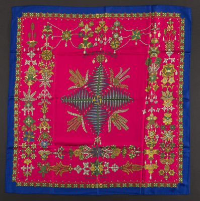 a close up of a pink and blue square with a cross on it