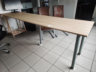 a desk with a computer monitor and a chair in the room