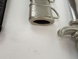 a silver object sitting on a table next to a knife